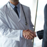 doctor businessman shaking hands