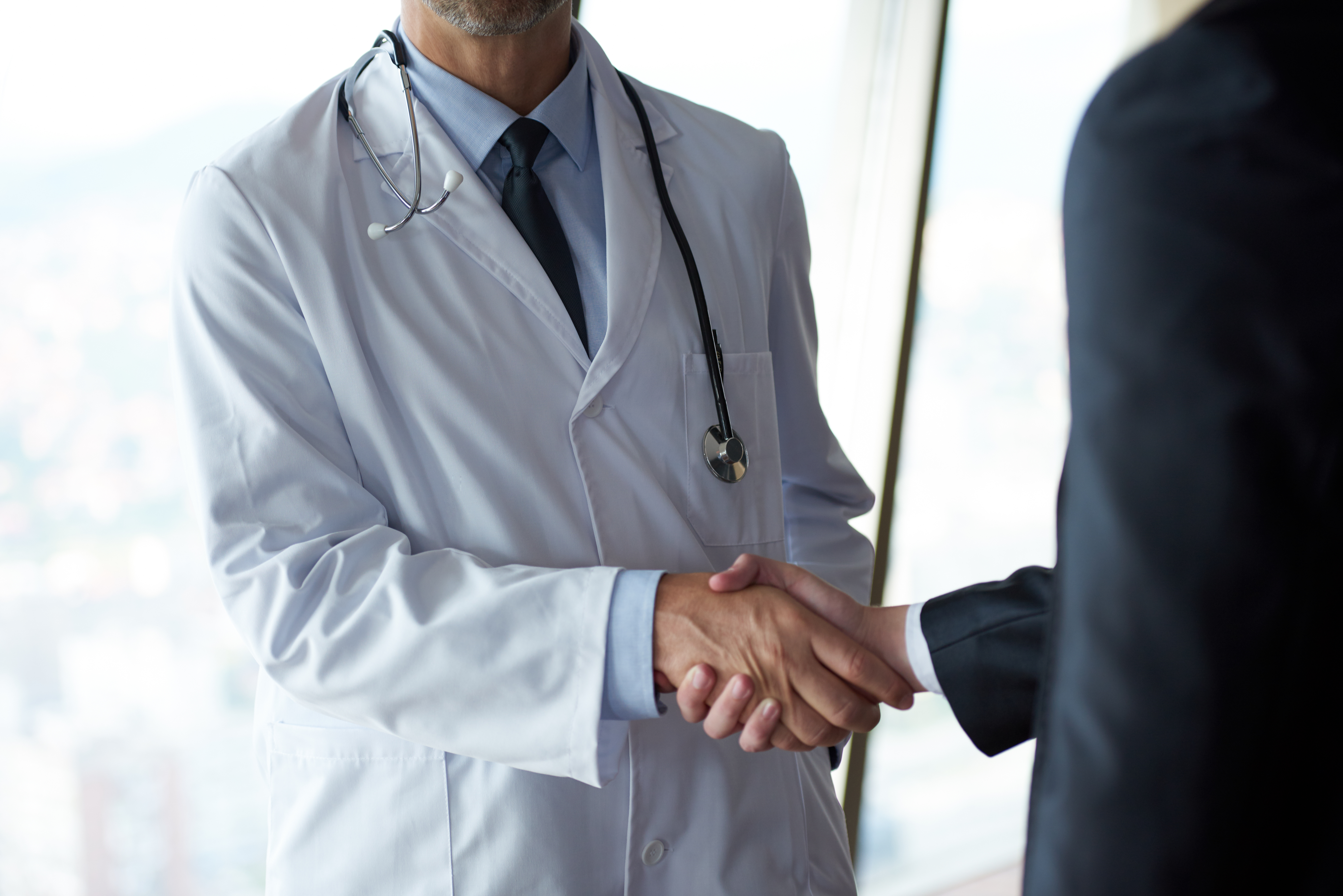 doctor businessman shaking hands