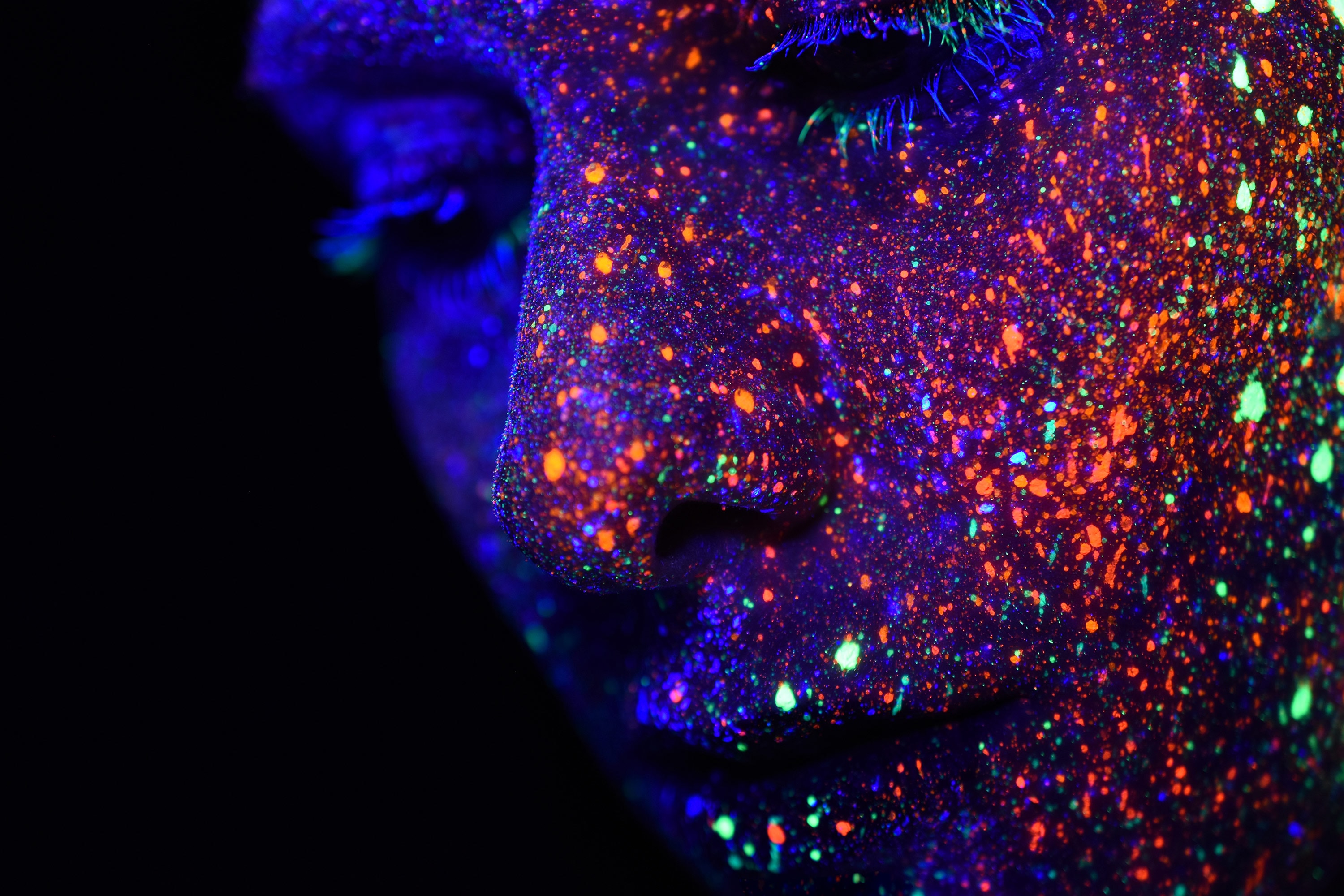 woman's face with colored points of light